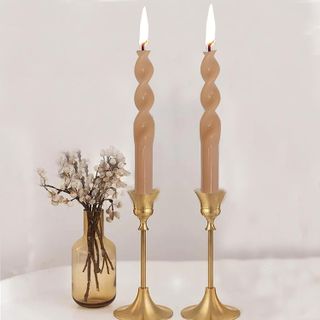 2 twisted taper candles in gold candlesticks