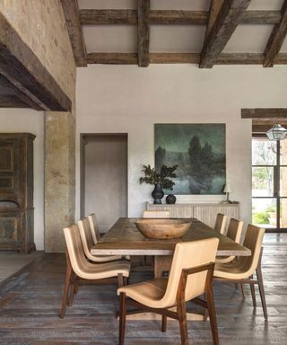 dining room with wooden table and chairs with wooden beams