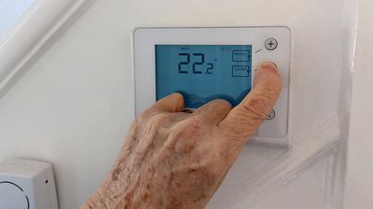 Elderly person turning down heating 