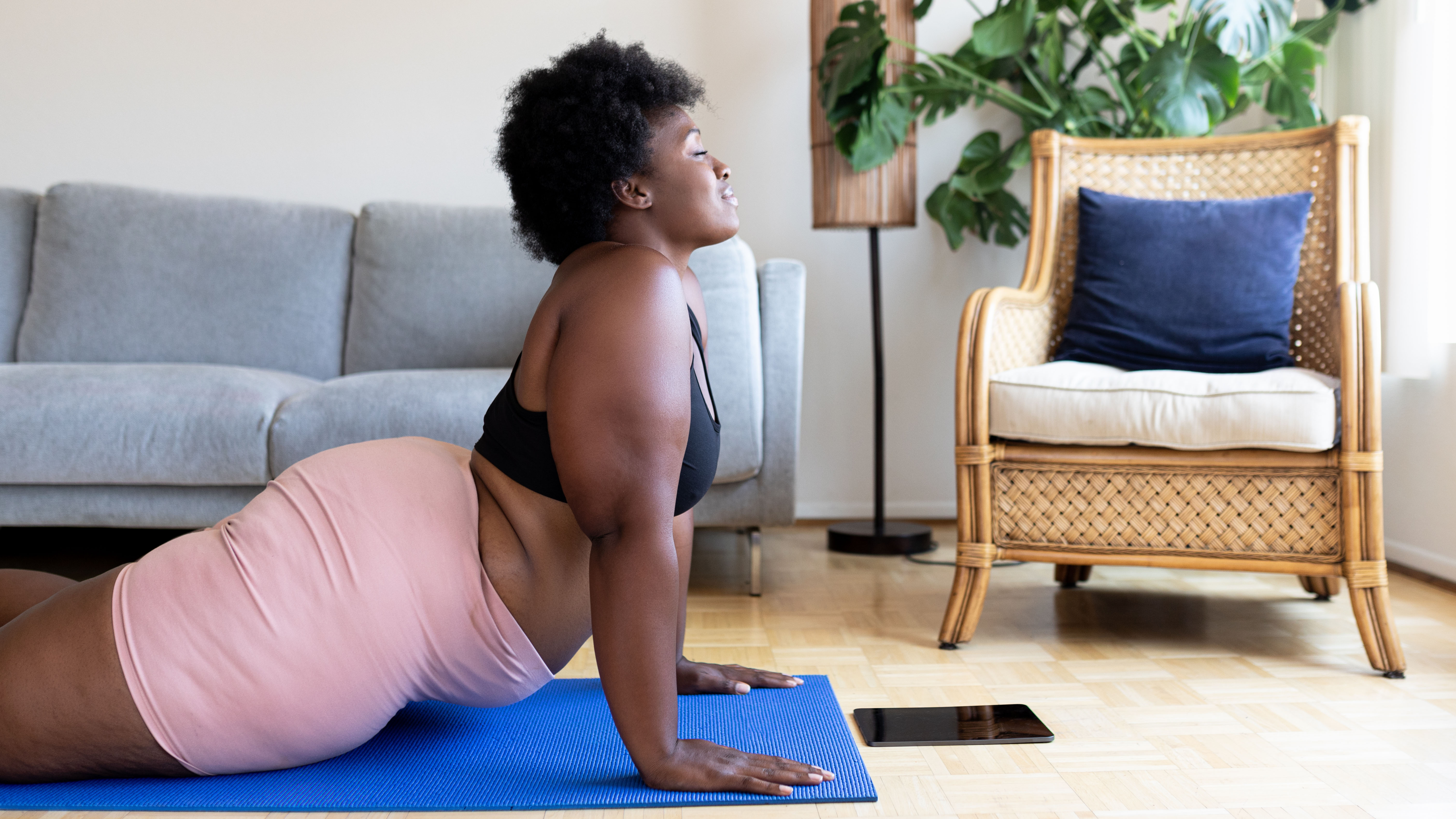 Woman doing low-impact yoga exercise at home
