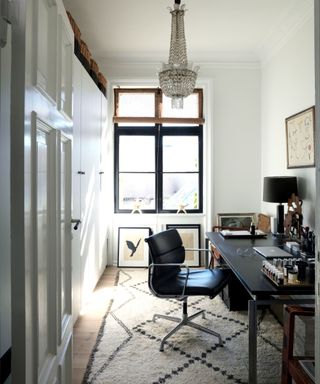 Office, black desk, rug, built in cupboards