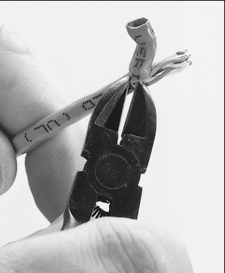 Use the wire stripper to strip only the insulation jacket off the cable.