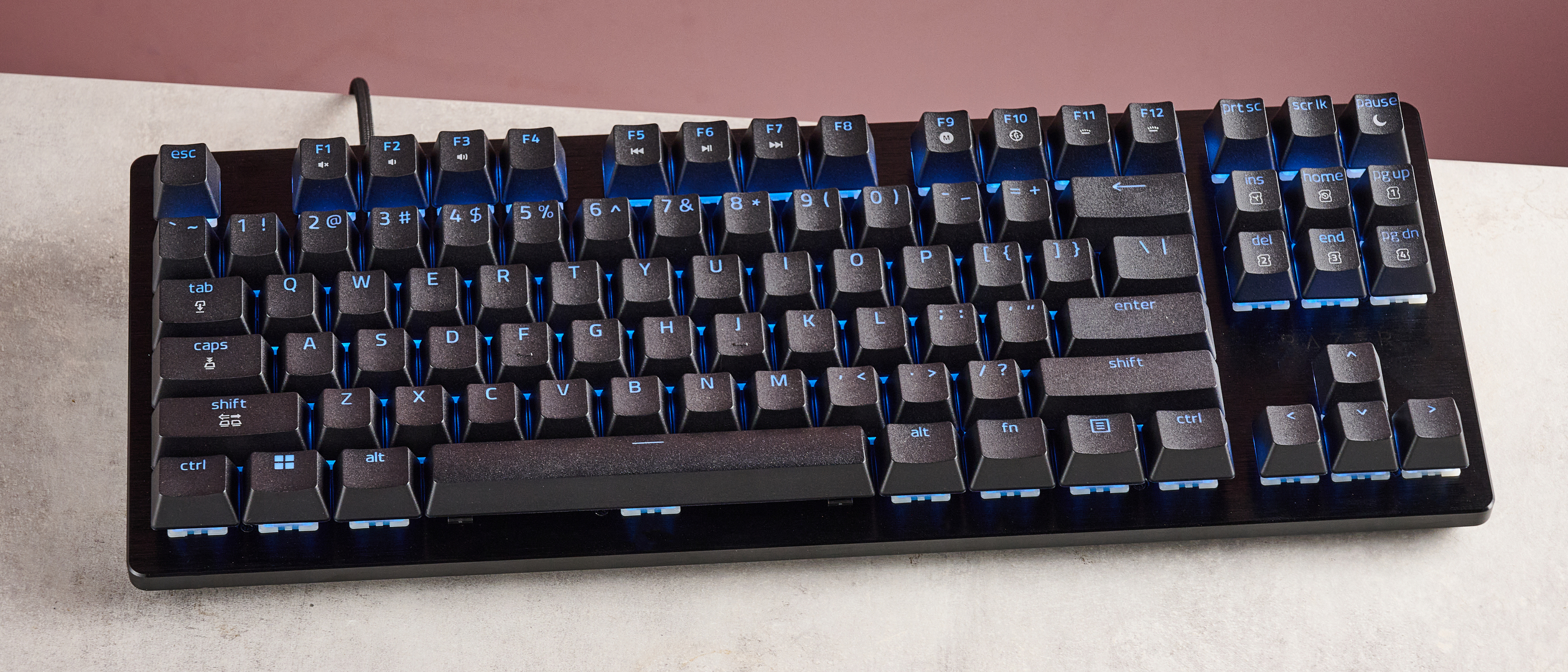top-down view of Razer Huntsman V3 HE Magnetic Tenkeyless 8KHz on desk with pink wall in background