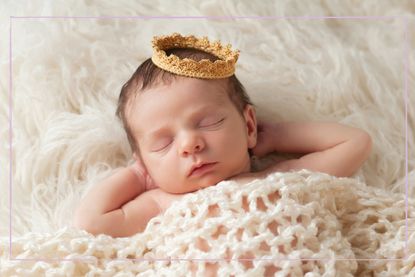 A sleeping baby wearing a crown