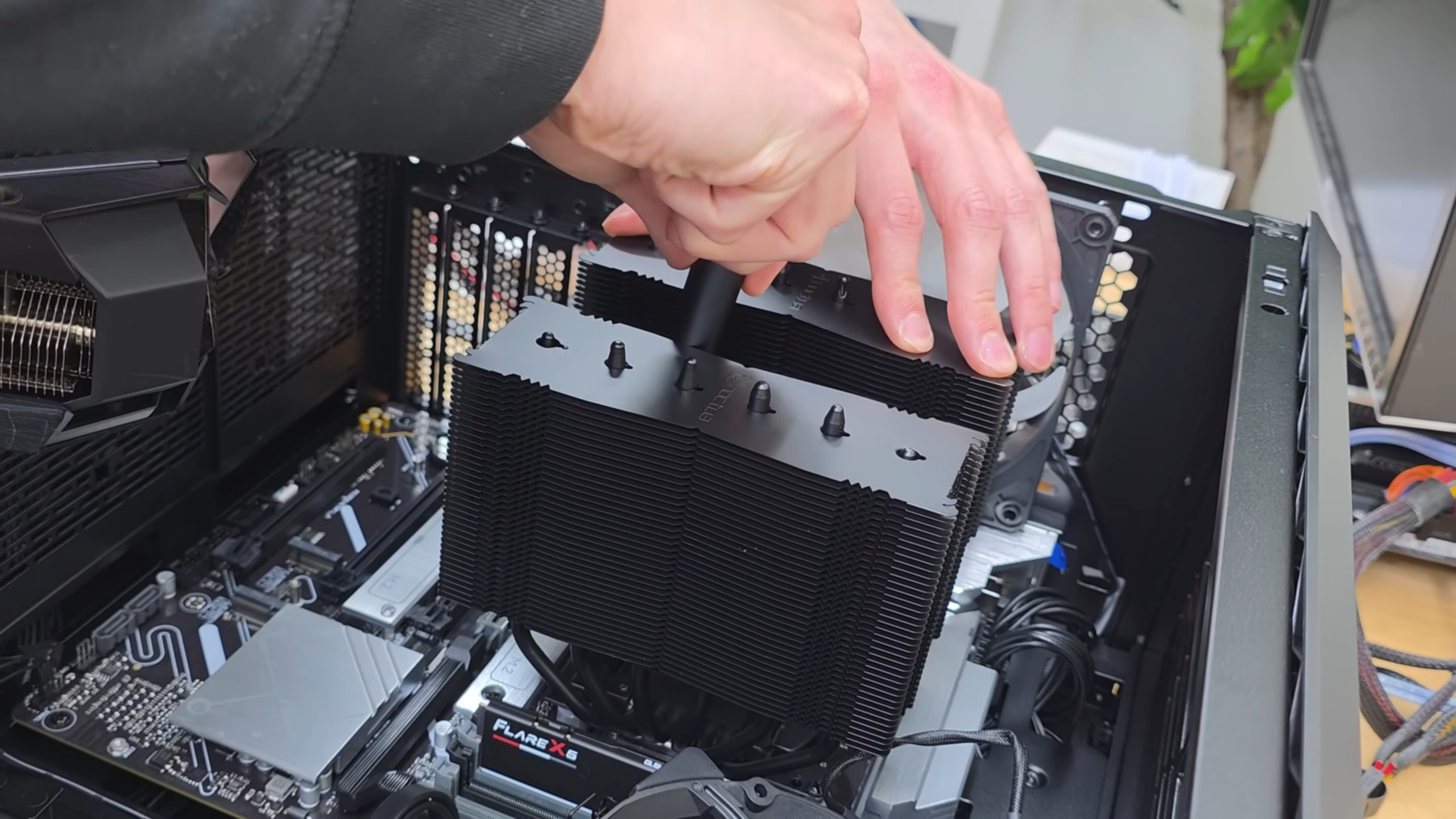 A large air cooler being installed on a motherboard