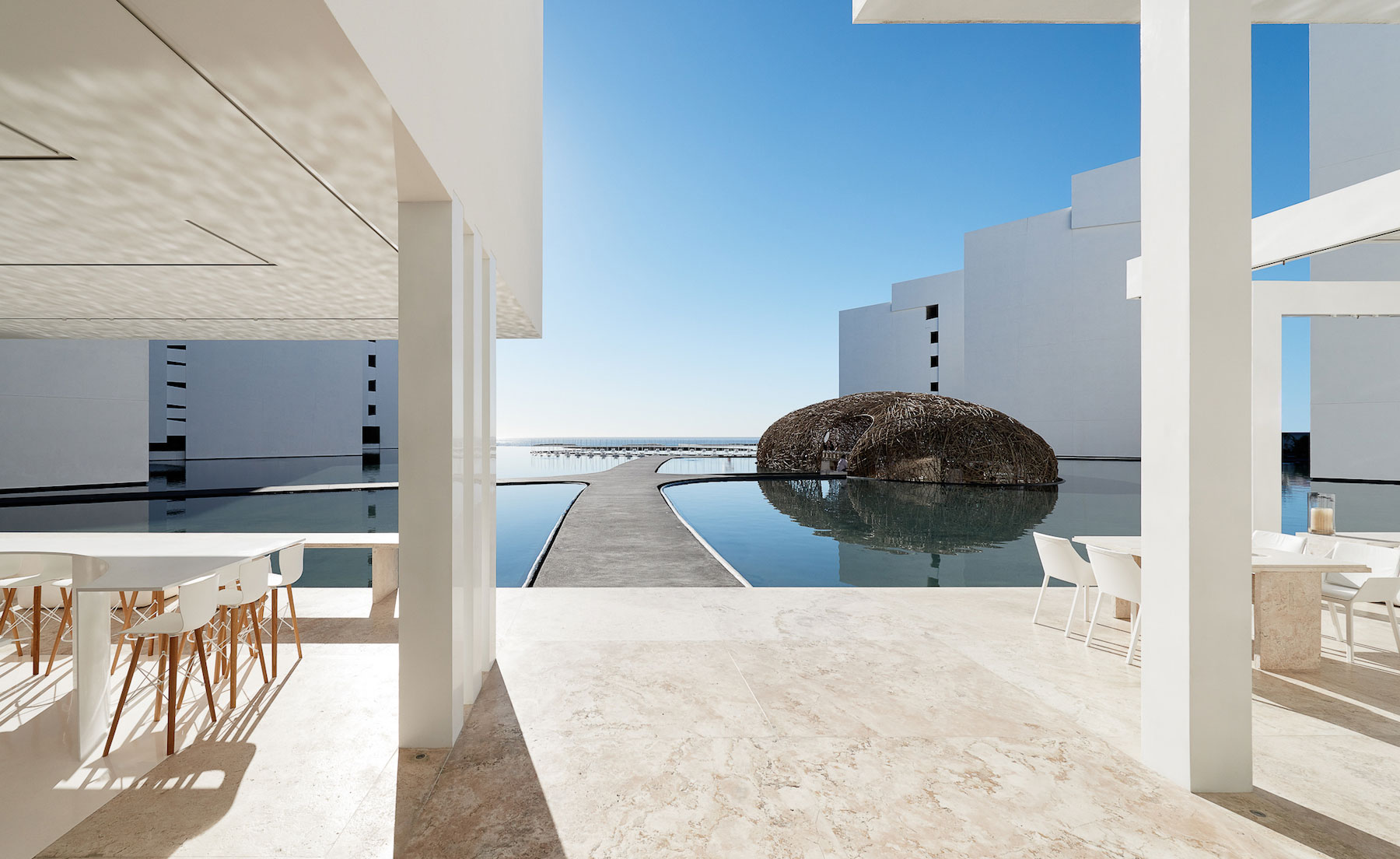 View from restaurant of water feature and woven-hut design