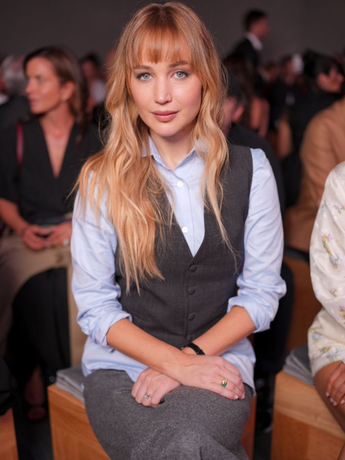 Jennifer Lawrence at a fashion show with warm, honey blonde hair