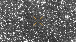 A blurry picture of stars with arrows pointing to where a comet is