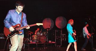 Lee Ranaldo plays his Thinline Telecaster Deluxe as Sonic Youth perform at the Forum, London, in 1996. Steve Shelley, Kim Gordon and Thurston Moore are is pictured in the background.