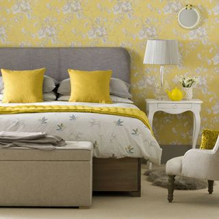 bedroom with bed and yellow wallpaper