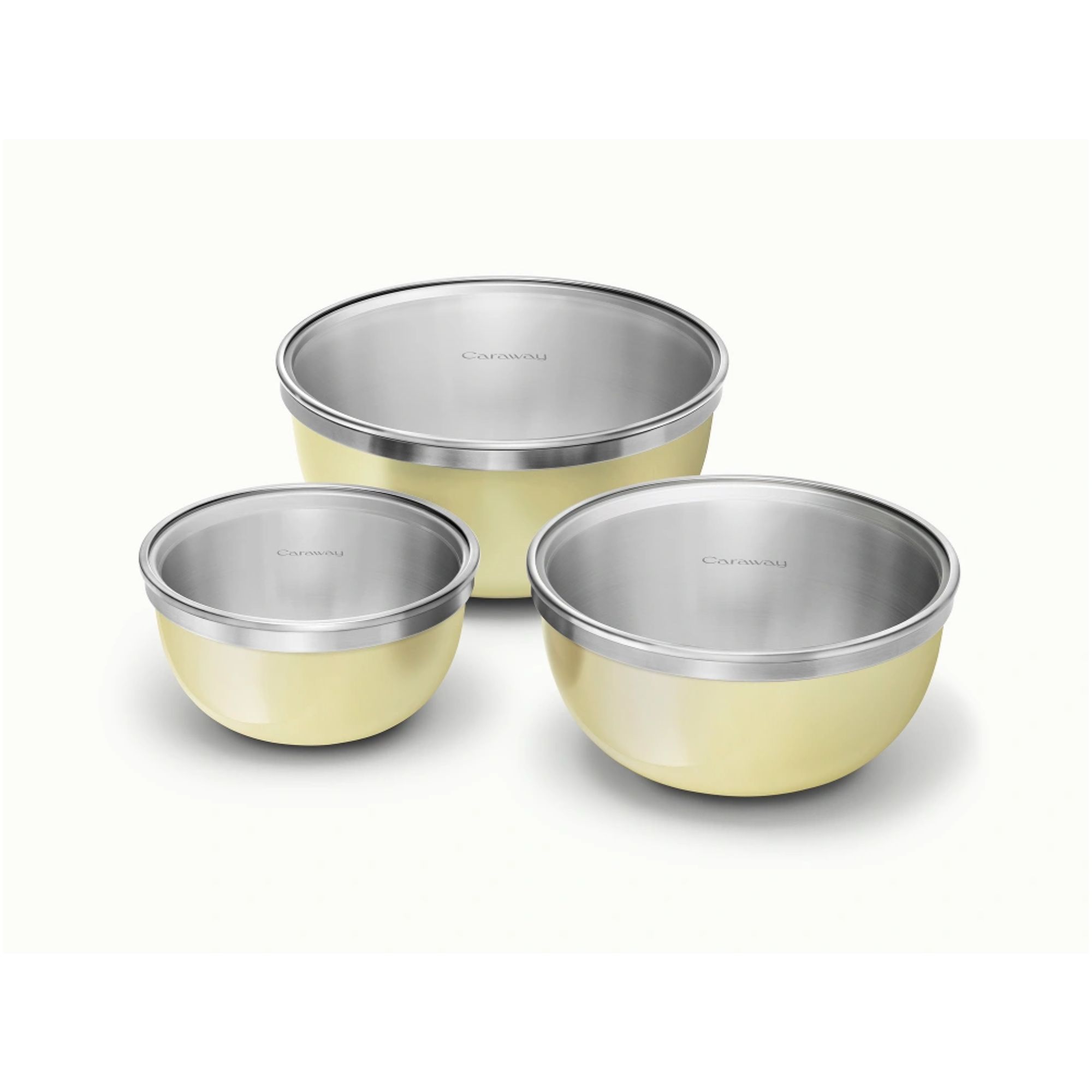 A set of three stainless steel mixing bowls with yellow exteriors, with glass lids on top. Each one smaller than the last.