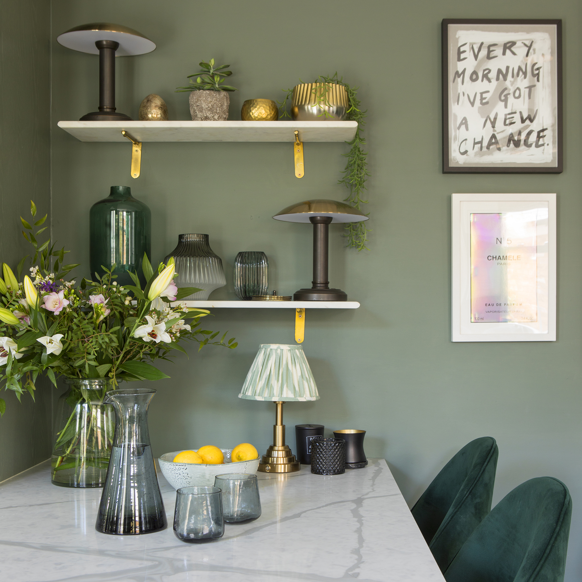 Green kitchen with shelves and lamps