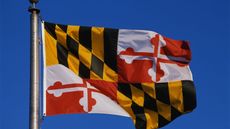 Maryland State flag flying in the sky for Maryland state tax guide