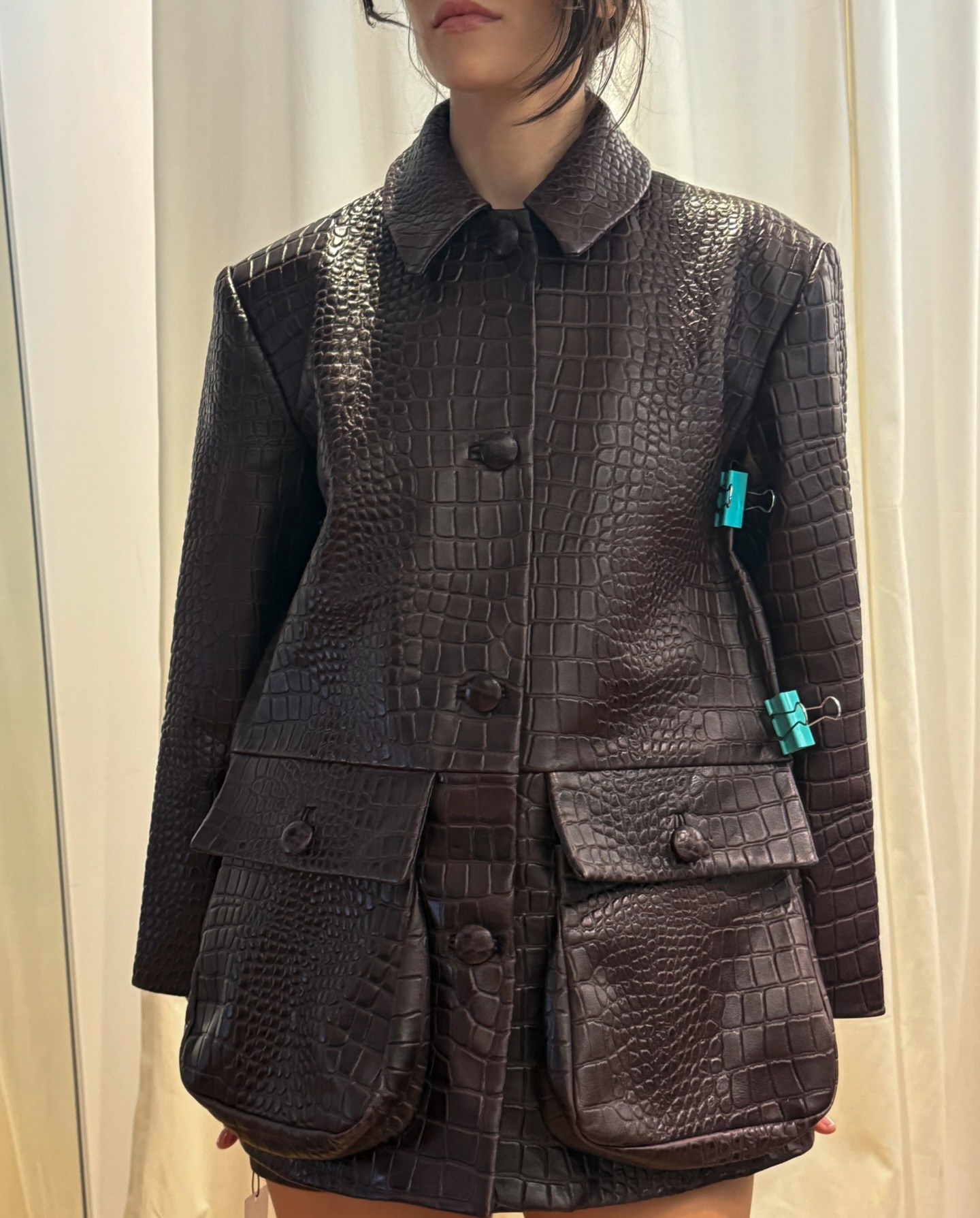 Woman wearing croc jacket, a very big spring 2026 jacket trend.