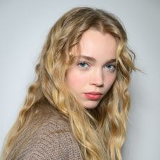 A model with her hair curled using the best heatless curlers.