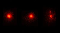 three blurry red splotches on a black background