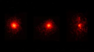 three blurry red splotches on a black background