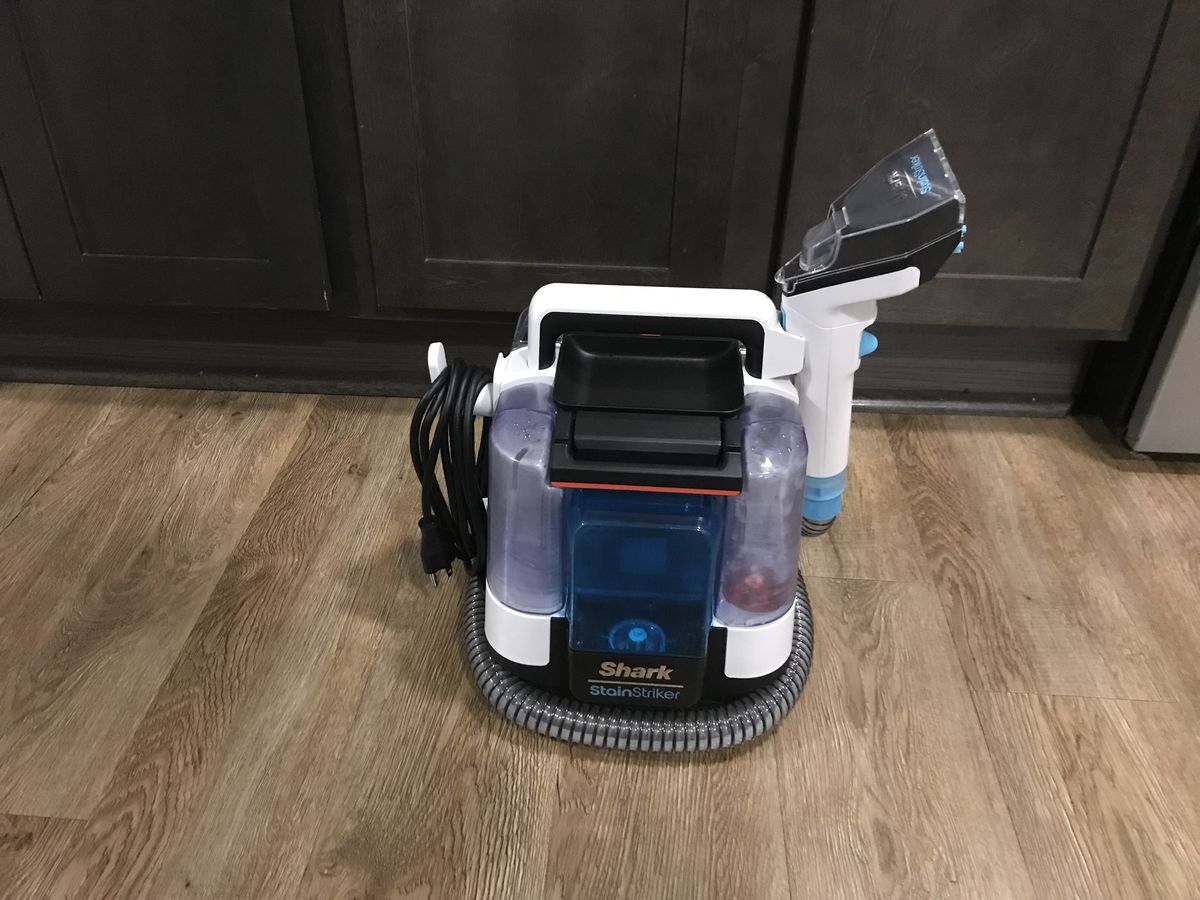 Shark Stain Striker on floor next to cabinetry