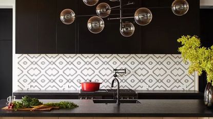 Large lightbulbs, black countertop, tile backsplash