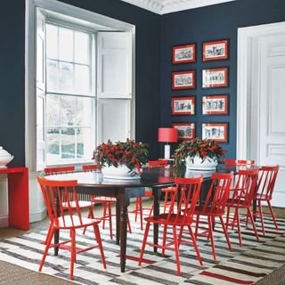 dining room with dining table with red chairs