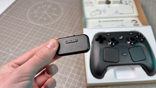 The Steam Controller on a desk during a teardown, with various parts removed.