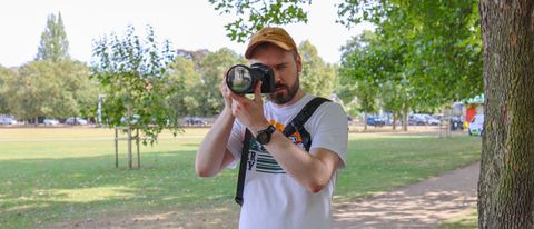 A man wearing the BlackRapid Blackline I Right Sling in a park