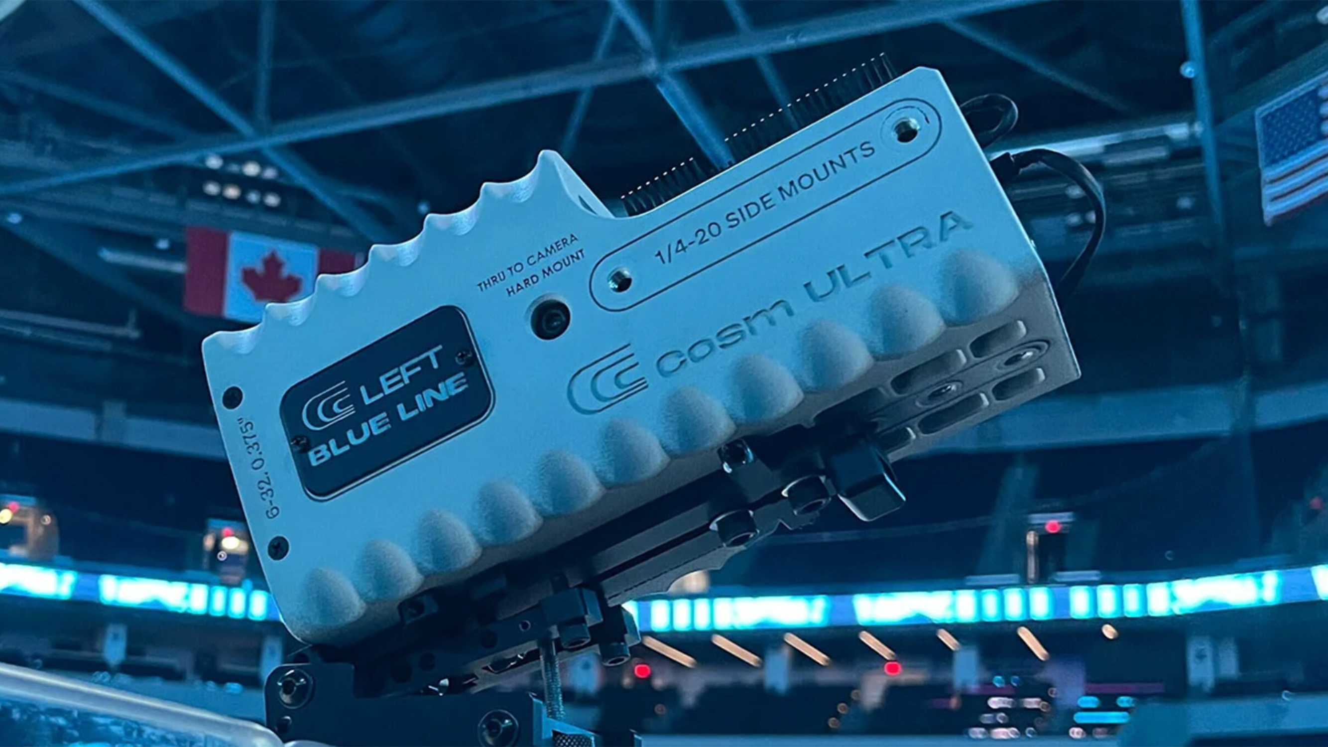 A white unmanned video camera fixed atop a plexiglass. 