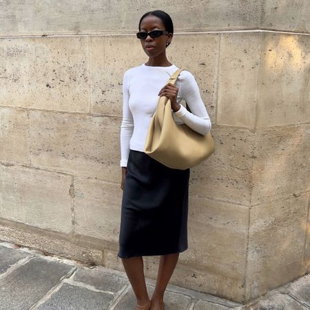 An image of @sylviemus wearing a Polene bag, one of the best French bag brands.