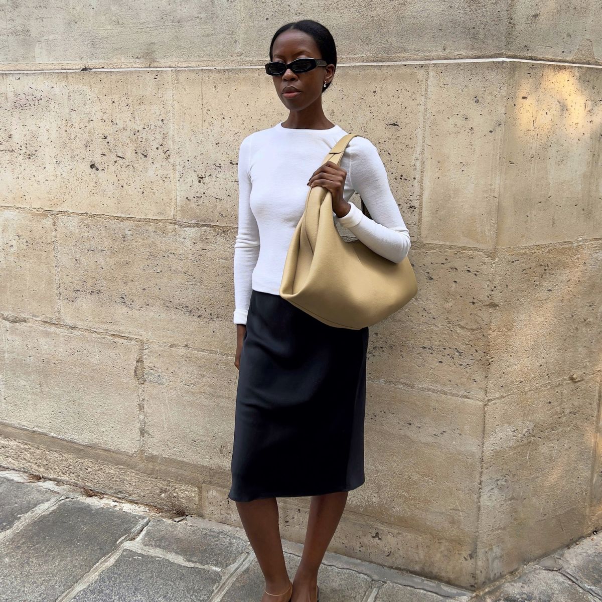 An image of @sylviemus wearing a Polene bag, one of the best French bag brands.