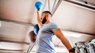 Man exercising with kettlebell in gym