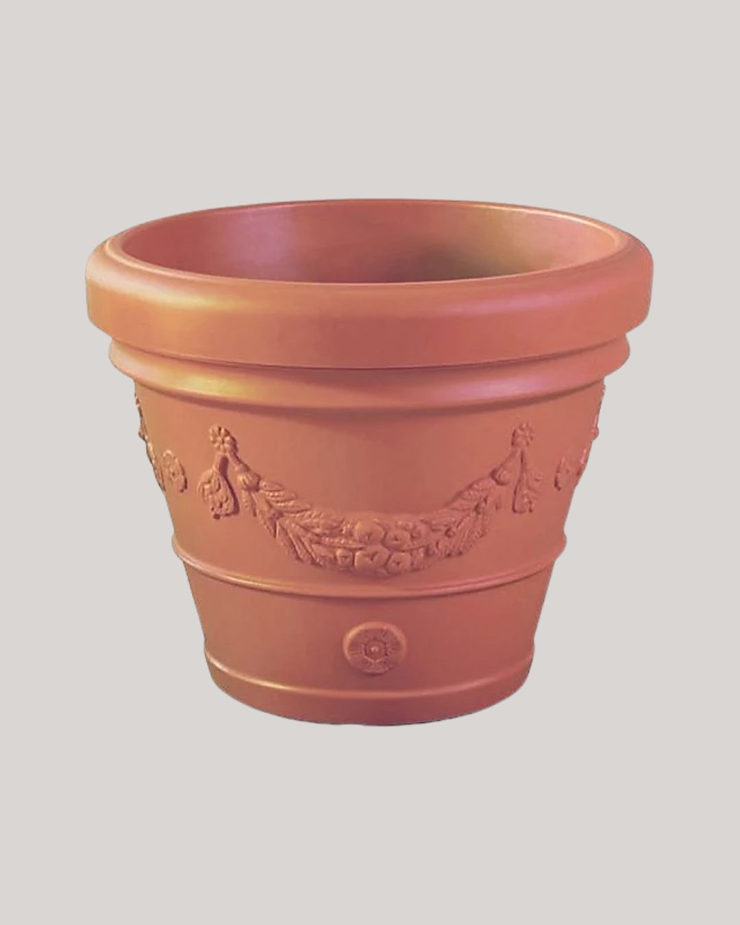 Orange Planter With Grape Design Embossed Surface 63l against pale gray background.