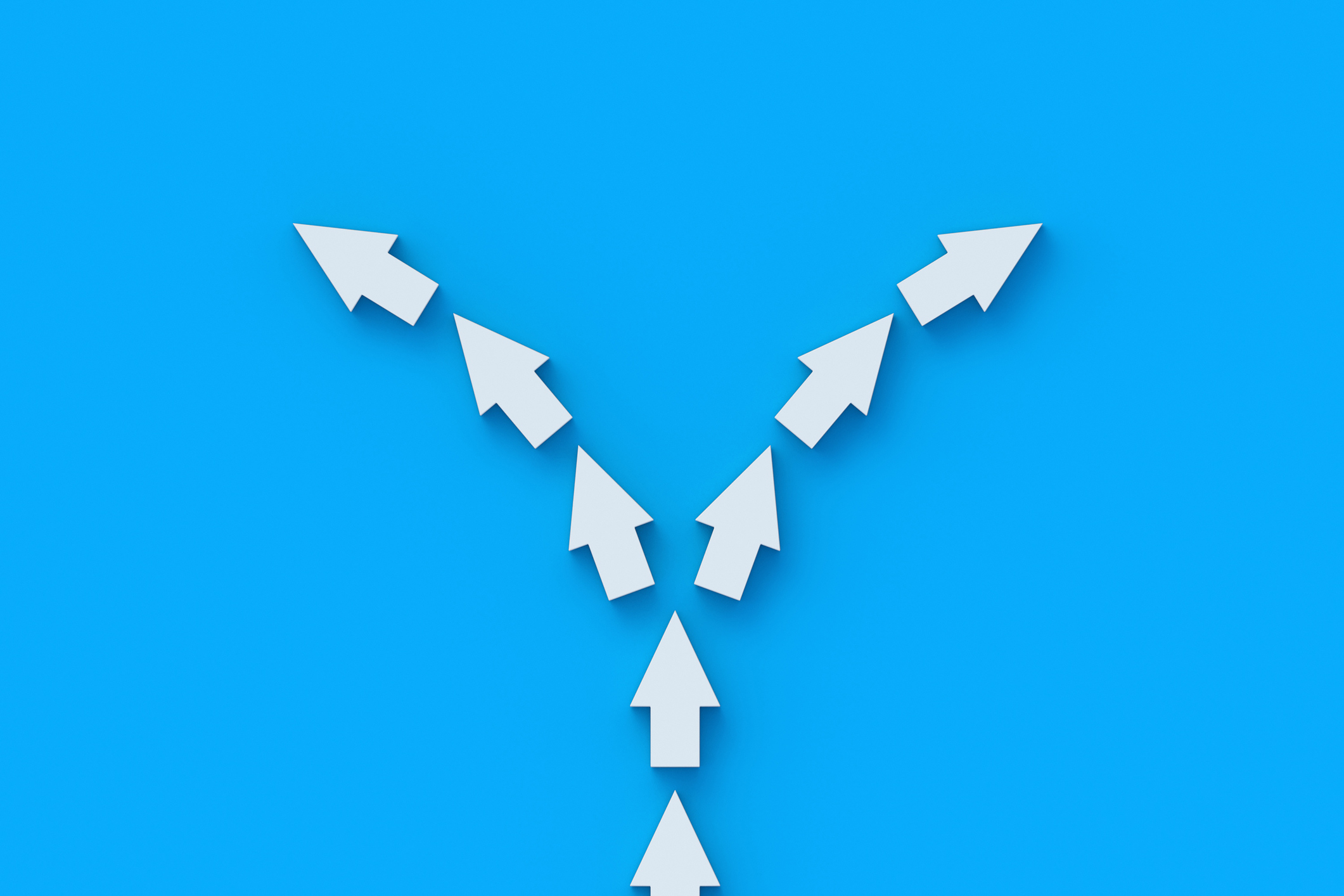 a line of white arrow splitting into two directions with a bright blue background