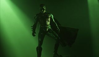 Batman Forever Chris O'Donnell Robin stands on a rock bathed in green light