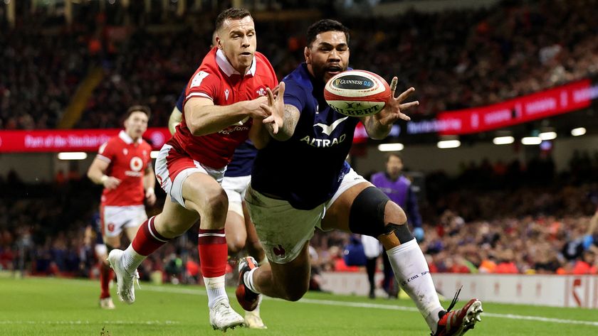 Two players lunge for the ball during the France vs Wales rugby match in the 2024 Six Nations