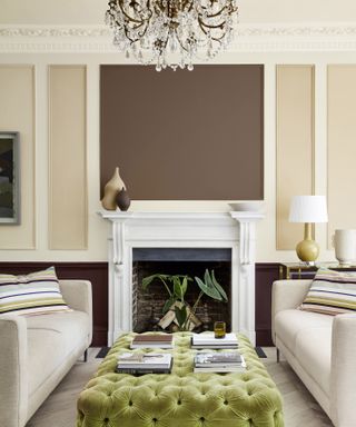Brown and beige living room with white fireplace and green sofa