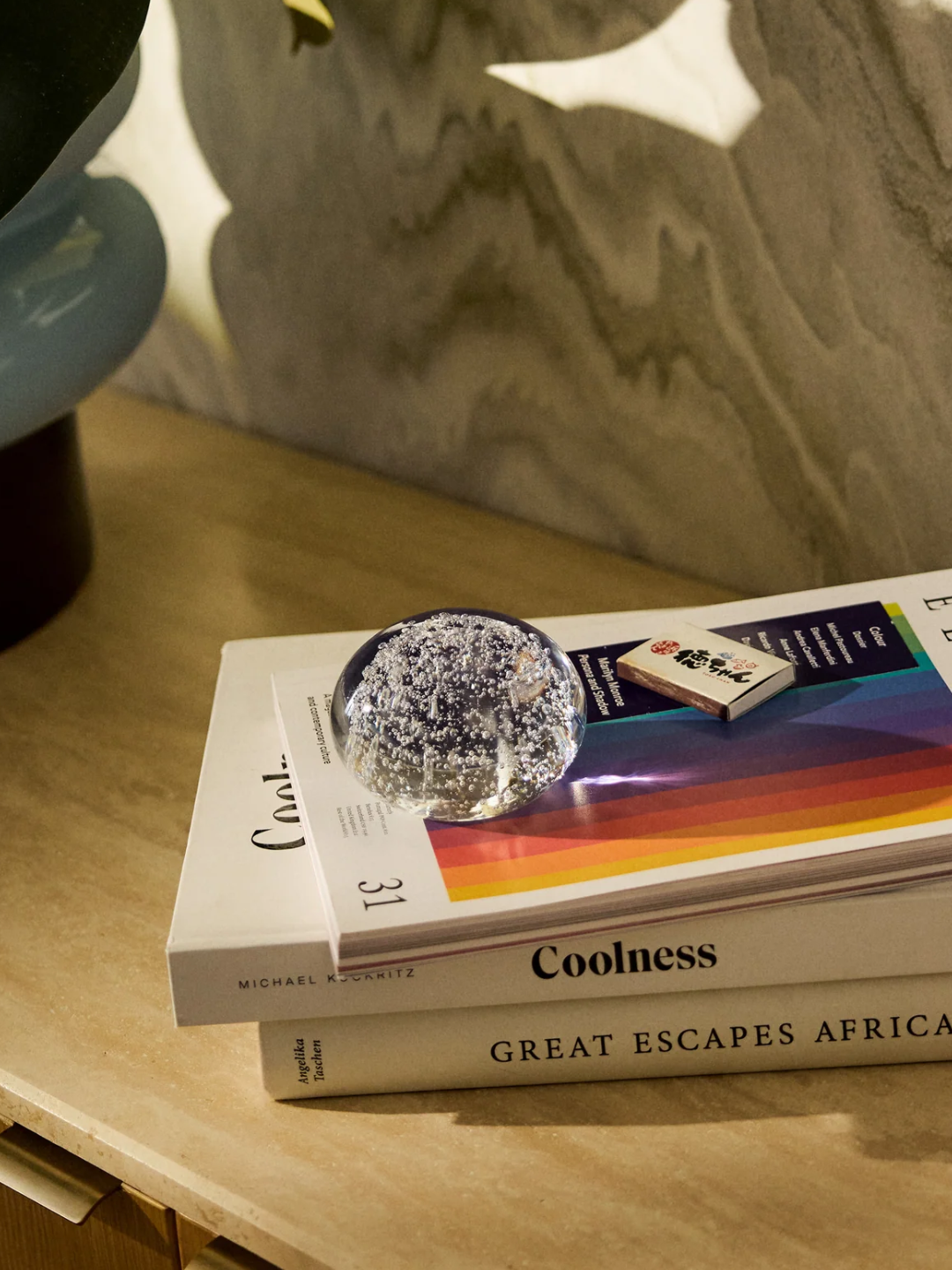 A bubbled glass sphere on a stack of books from Westwing