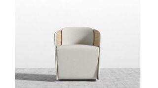 ROVE CONCEPTS Atticus Chair on a gray floor, in front of a white wall