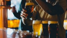 bartender pouring pints at a bar