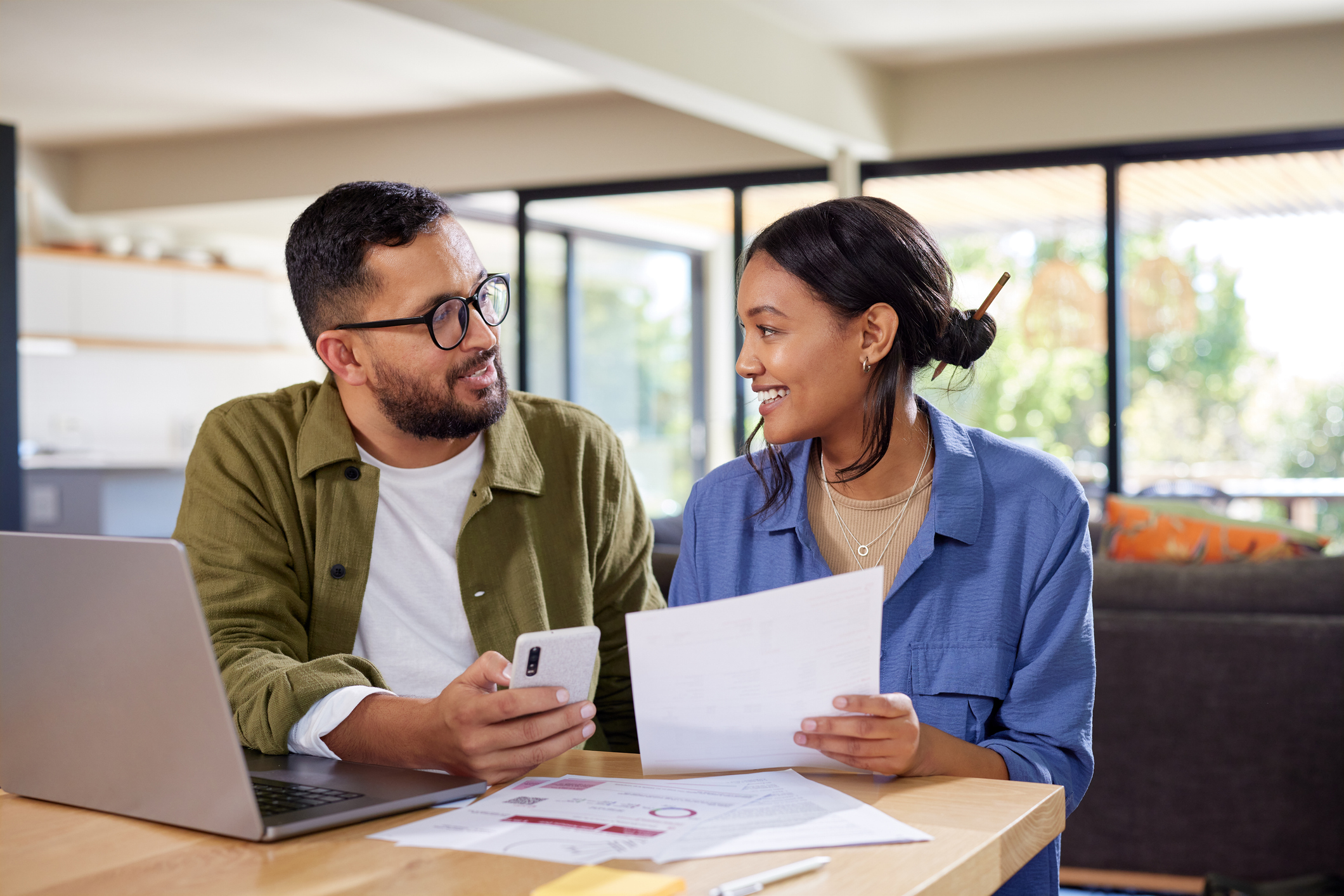 a couple discussing a financial decision at a table
