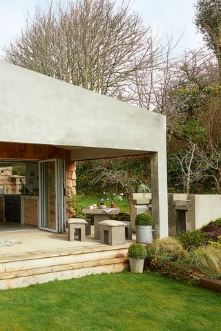 garden decking area with modern concrete furniture and built in BBQ