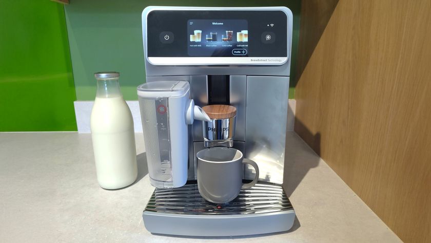 Philips Caf&eacute; Aromis coffee maker on kitchen counter with bottle of oat milk