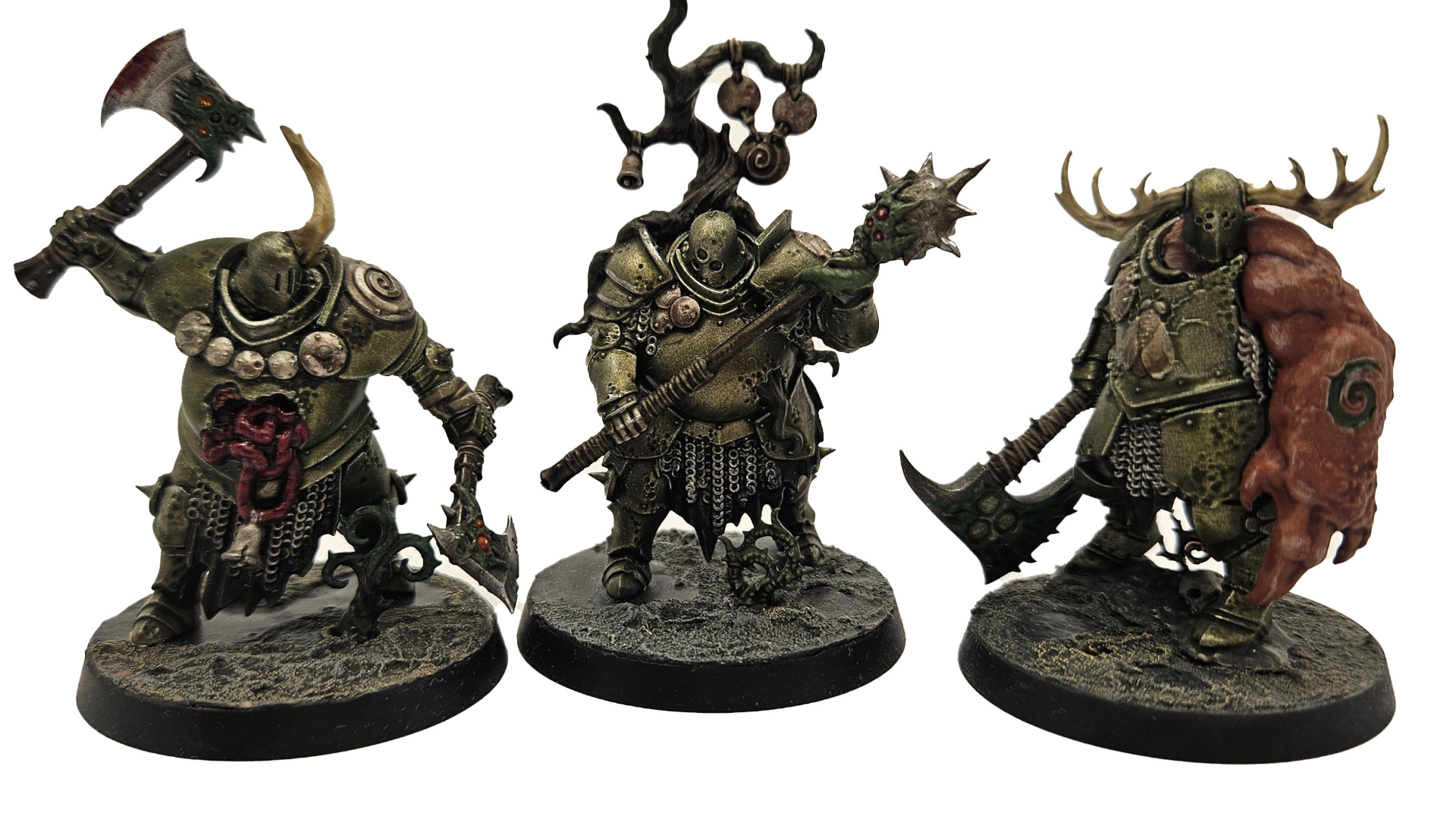 A trio of fully painted Nurgle miniatures against a plain background