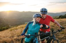 Older couple mountain biking 