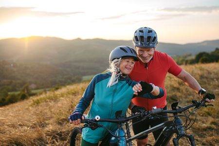 Older couple mountain biking 