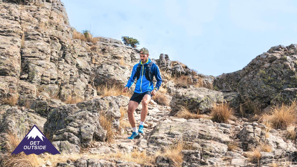 a male runner navigating his way across a trail route