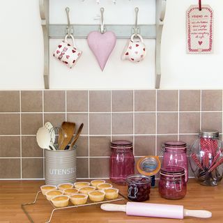 kitchen with wooden table and pink jars