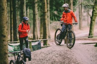 Mountain bike coach Katy Curd laughing with rider