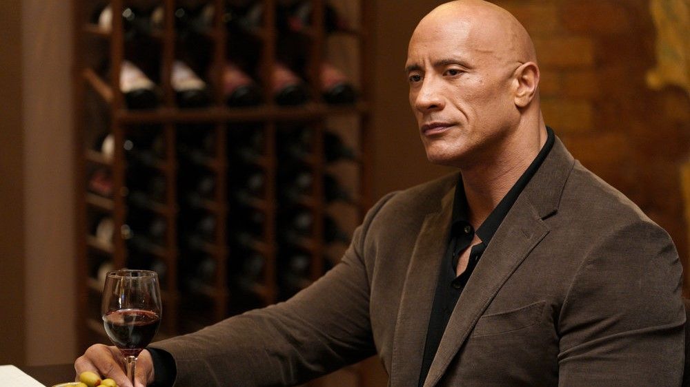 Dwayne Johnson holding a glass of wine in Young Rock