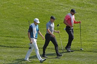 rory mcilroy shoots three under with new caddie