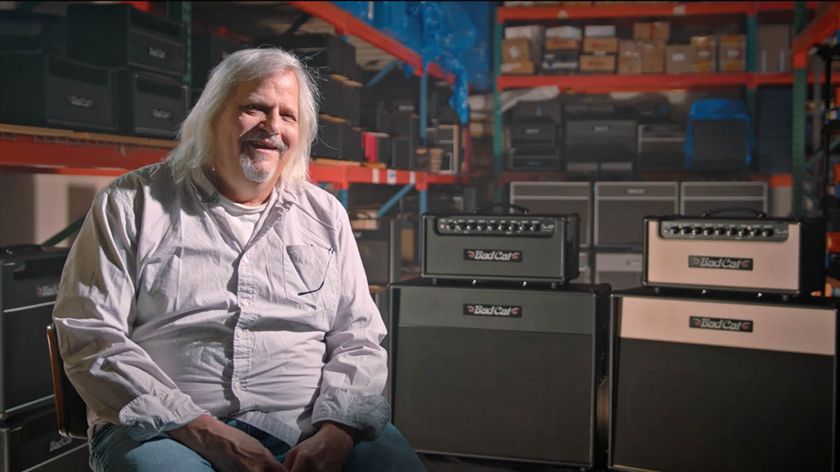 The late Mark Sampson, co-founder of Matchless amps and Bad Cat, introduces the new Bad Cat Era 30. He wears a light grey shirt, with the amps and cabs in the background.